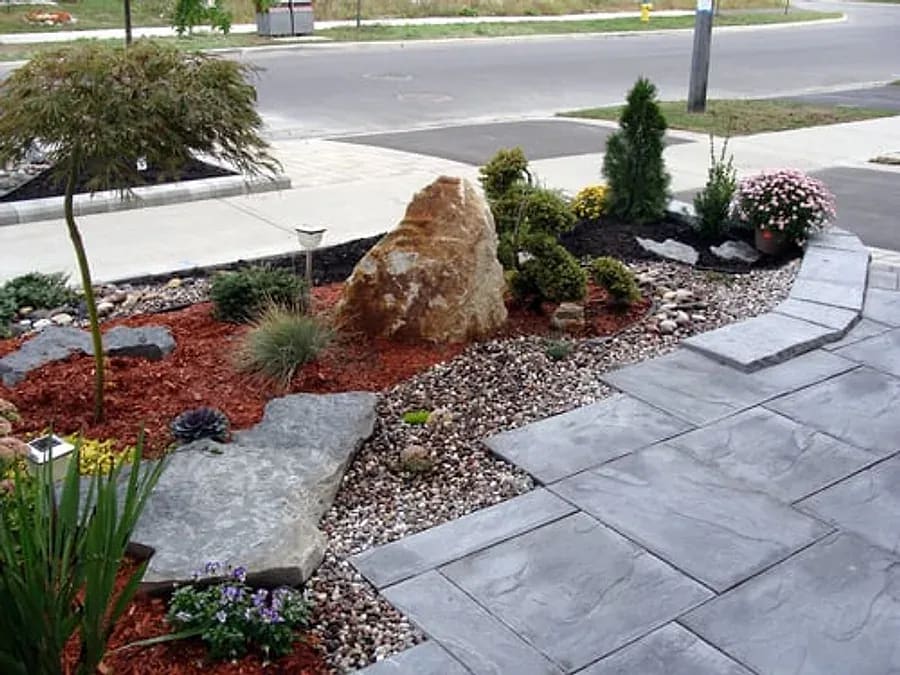Desert landscape design with boulders, agave and drought-tolerant plants installed at a Mesa, AZ home